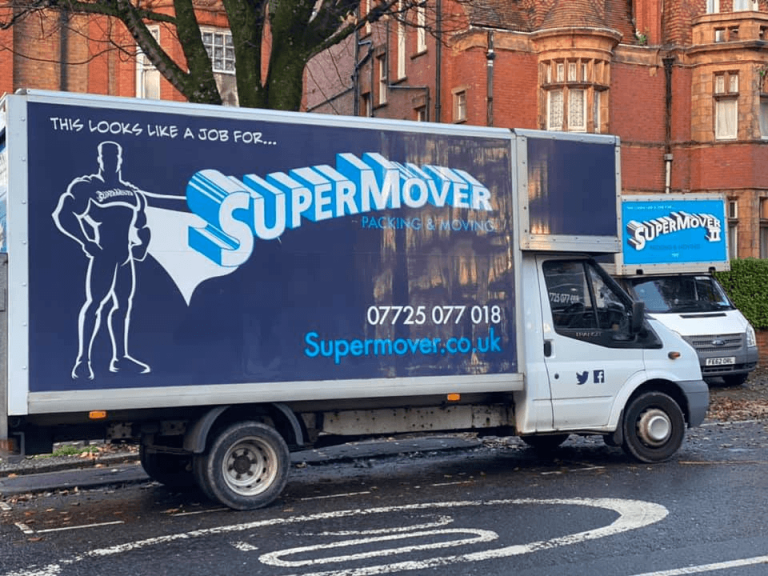 Supermover removals vans parked beside red-brick buildings