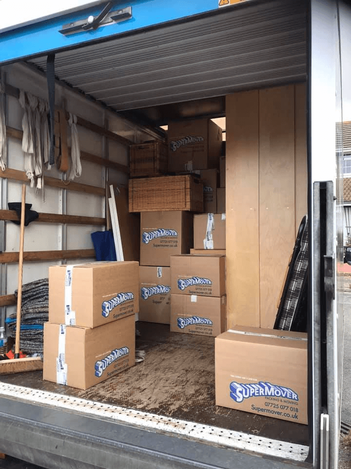Cardboard moving boxes and furniture loaded inside a Supermover removals van